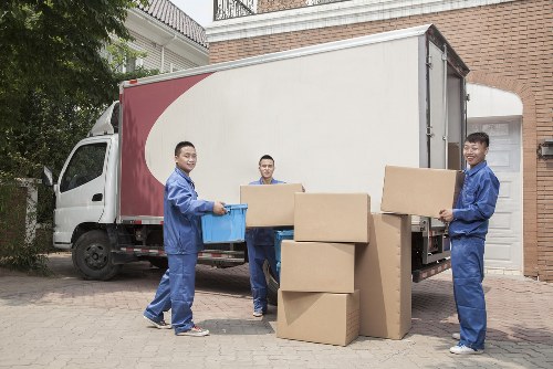 Mover handling boxes safely outside a Fulham property