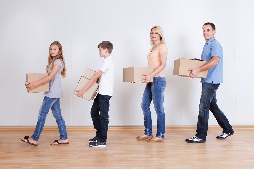 Local moving team managing boxes and furniture in a Fulham property