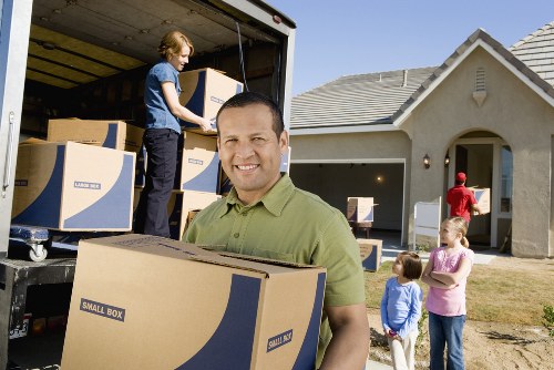 Moving team handling furniture in a Fulham property